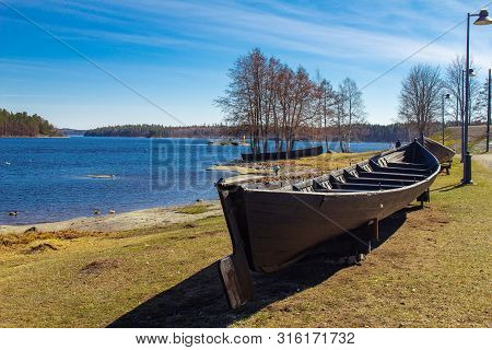 Finland. Savonlinna. Southern Savonia: Exhibit Ancient Boat On The Lake At Spring Sunny Day Near The