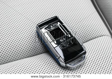 Closeup Inside Vehicle Of Wireless Blue Leather Key Ignition On White Leather Seat. Wireless Start E