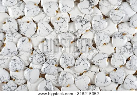 Many Heart-shaped Semi-precious Stones Of White Howlite As Background
