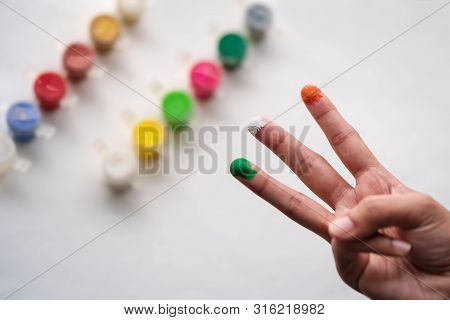Woman Showing Tricolor Of Indian Flag With Her Painted Fingers. Independence Day Background Concept.