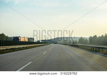 Warshaw, Poland - July, 26, 2019: landscape with the image of a road in Poland at sunset