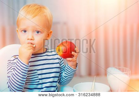Eat Healthy. Toddler Having Snack At Home. Child Eat Porridge. Kid Cute Boy Blue Eyes Sit At Table W