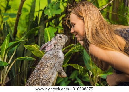 Woman Holding A Rabbit. Cosmetics Test On Rabbit Animal. Cruelty Free And Stop Animal Abuse Concept