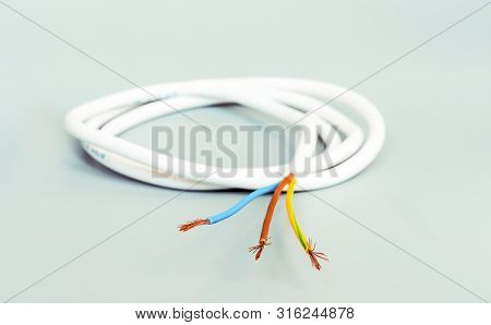 Three-core Cable In White Isolation On A Gray Background