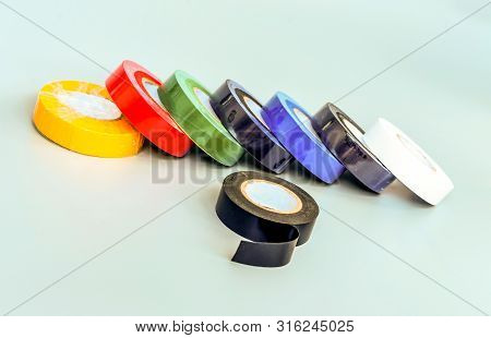 Set Of Multicolored Insulating Tapes On Gray Background