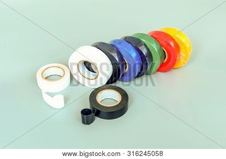 Set Of Multicolored Insulating Tapes On Gray Background