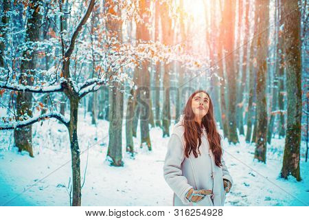 Girl Having Fun In Winter Park. Winter Portrait Of Young Beautiful Brunette Woman In Snow Garden