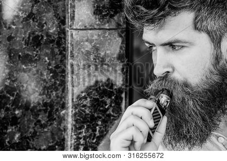 Bearded Man Smoking Vape. Man With Beard Breathe Out Smoke. Smoking Electronic Cigarette. Stress Rel