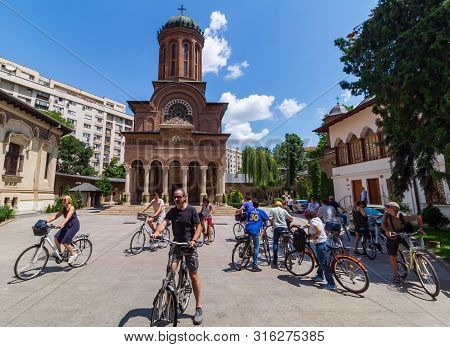 Bucharest, Romania - July 11, 2019: Tourists On Bicycles Are Seen In Front Of The Church Of Antim Mo