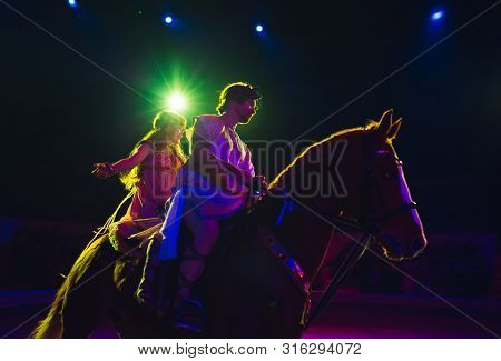 Horses In The Circus. Speech Horses With Trainers On The Stage Of The Circus