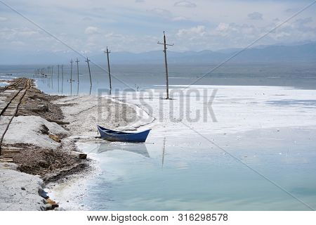 Salt Lake landscape with blue boat, named Chaka Salt Lake, is located in Qinghai Province, China.                 