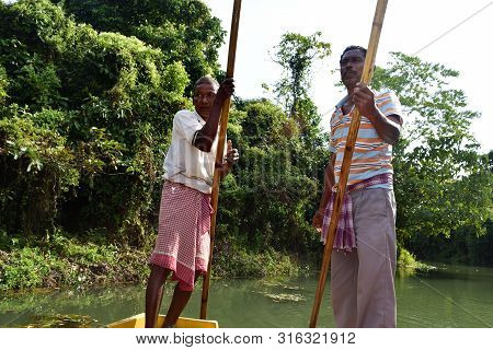 Boatmen Drive Boat Through Buxa Tiger Reserve In West Bengal, India. A Boat Ride Through The Jungle.
