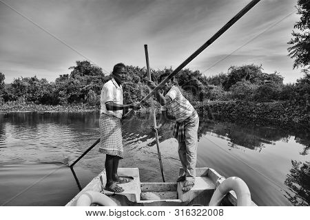 Boatmen Drive Boat Through Buxa Tiger Reserve In West Bengal, India. A Boat Ride Through The Jungle.