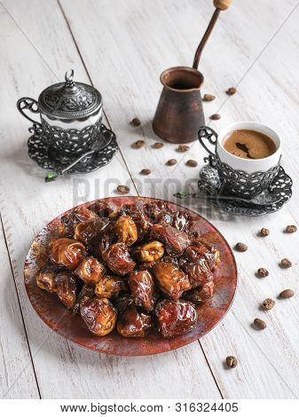 Organic Sweet Dates With Syrup And Black Coffee. Ramadan Kareem Holiday Concept.
