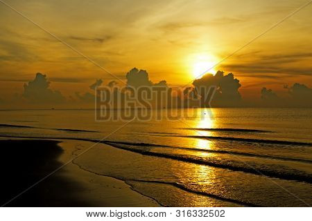 Sunrise In The Sea Silhouettel On Beach At Thung Wua Lan Beach, Chumphon Province Thailand
