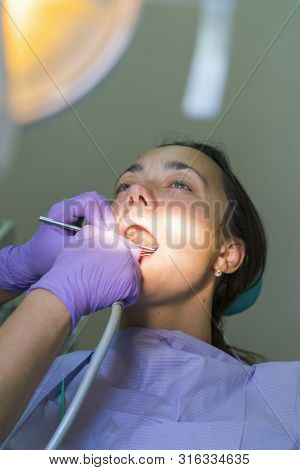 Dentist And Patient In Dentist Office. Close-up Of Dental Drill Use For Patient Teeth In Dentistry O