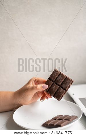 Sugar Addiction, Stressful Lifestyle, Dietary And Medical Concept. Young Woman Breaking Chocolate Ba