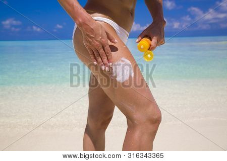 Woman Applying Sunscreen