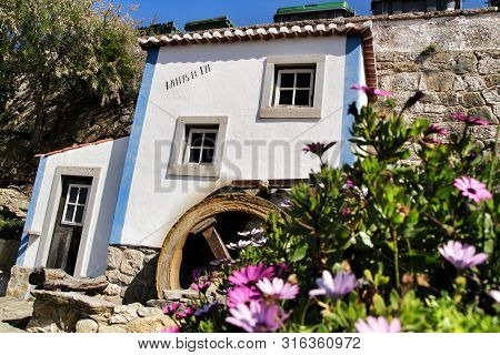 Azenhas Do Mar, Sintra, Lisbon, Portugal- March 19, 2019: Beautiful And Colorful Waterwheel In Azenh