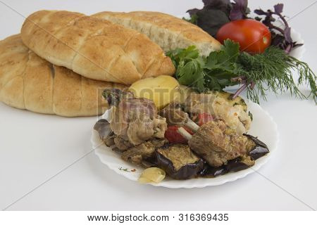 Traditional Azerbaijani Dish - Saj With Meat And Vegetables. A Plate With A Dish On A White Backgrou