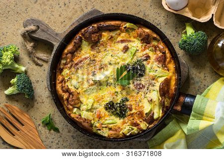 Frittata With Sausage And Vegetables In Skillet. Top View.