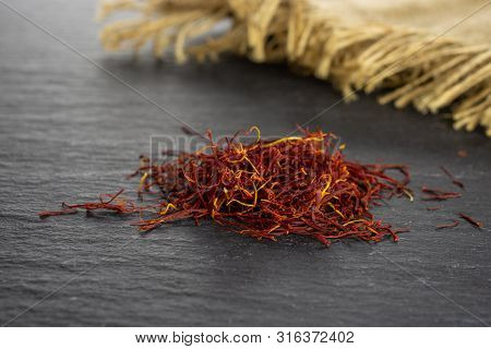 Lot Of Whole Dry Shaffron Thread And Jute Cloth On Grey Stone