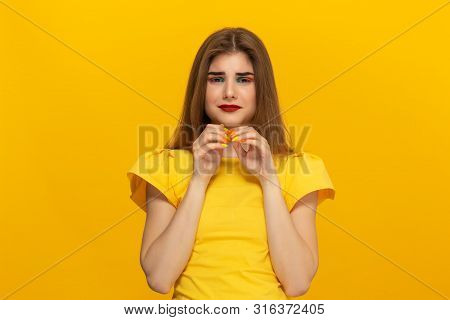 Beautiful Young Lady In A Casual Clothing Holding Hands Expressing Emotion Of Pleading For Apologize