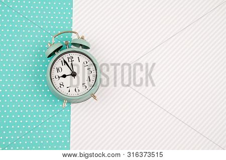 Flat Lay With Vintage Alarm Clock Over The Bastel Background