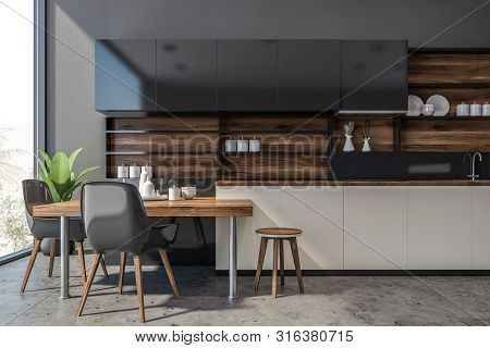 Gray And Wooden Kitchen With Counters And Table