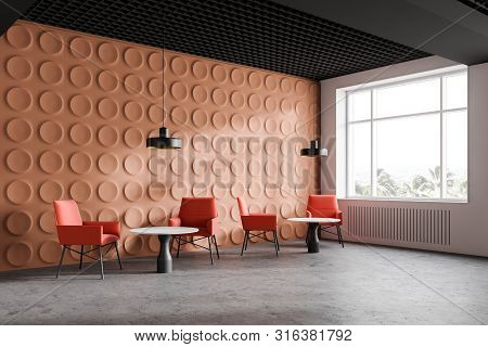 Orange Modern Office Waiting Room Corner With Geometric Pattern Walls, Concrete Floor, Bright Orange