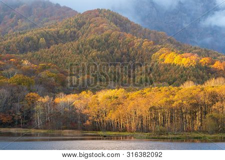 Beautiful Autumn View Of Kagami Lake Or Mirror Pond In Togakushi, Nagano, Japan