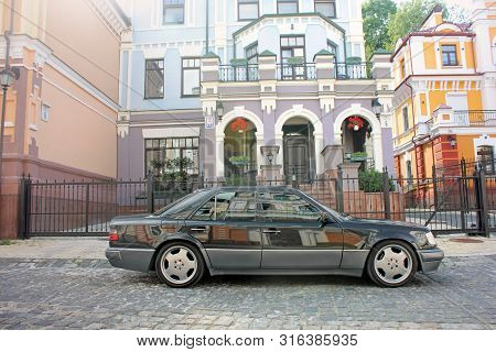 Kiev, Ukraine - September 6, 2013: Mercedes E500 W124 Wolf On The Background Of Beautiful Old Houses