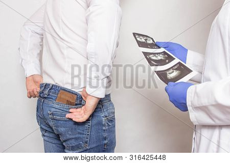 Doctor Urologist Holds A Picture Of An Ultrasound Examination Of The Patients Prostate Gland And Pre