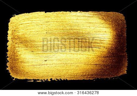 Creative brushstrokes of gold paint isolated on a black background. Gold paint texture.Acrylic gold paint. Smears of cosmetics, blush, highlighter, eye shadow, lipstick.
