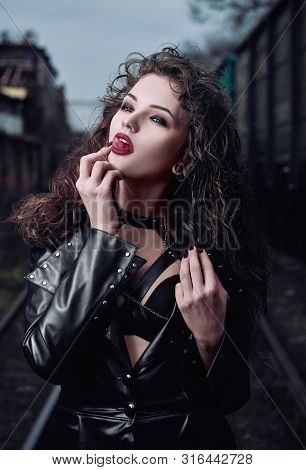 Portrait Of A Seductive Vamp Woman (informal Model) Dressed In Leather Coat
