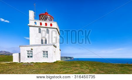 Landscape With White Lighthouse At Cape Dyrholaey. 
Location: Cape Dyrholaey (cape Portland), Near V