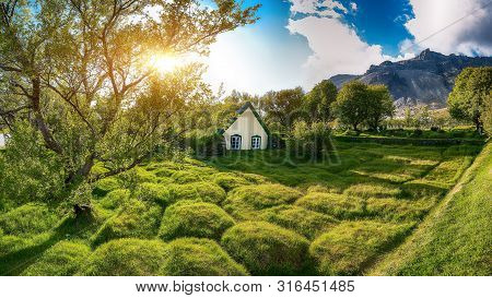 Picturesque View Of  Turf-top Church Hofskirkja During Sunset. Location: Village Of Hof, Skaftafell,