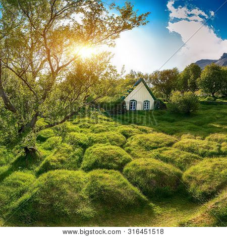 Picturesque View Of  Turf-top Church Hofskirkja During Sunset. Location: Village Of Hof, Skaftafell,