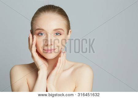 Portrait Of Beautiful Woman With Natural Make Up Touching Her Face.
