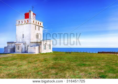 Landscape With White Lighthouse At Cape Dyrholaey. 
Location: Cape Dyrholaey (cape Portland), Near V