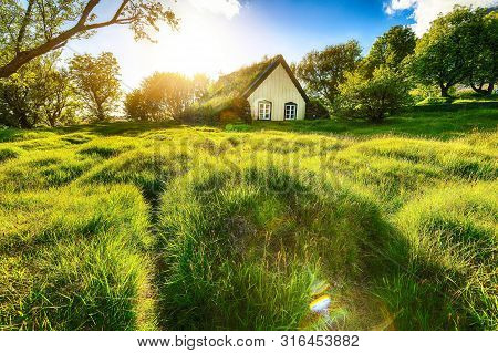 Picturesque View Of  Turf-top Church Hofskirkja During Sunset. Location: Village Of Hof, Skaftafell,
