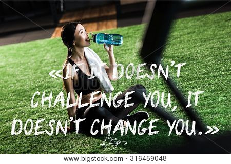 Selective Focus Of Happy Woman Sitting On Grass And Drinking Water With If It Doesnt Challenge You, 