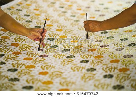 August 11 2019, Surakarta Indonesia : Close Up Hand To Make Batik On The Fabric With Canting With Bo