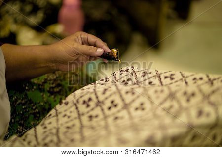 August 11 2019, Surakarta Indonesia : Close Up Hand To Make Batik On The Fabric With Canting With Bo