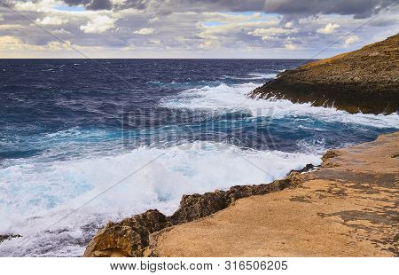 Huge Waves Crash On Cloudy Day. Kemmuna Island