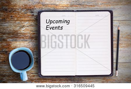 Text With Upcoming Events And Coffee Cup, Notebook,pencil On Grunge Wooden Table. Top View With Copy