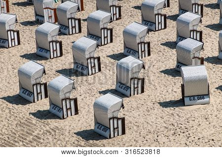 Beach Chairs On The Baltic Sea Coast In Goehren, Germany.