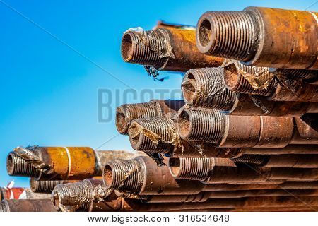 Oil Drill Pipe. Rusty Drill Pipes Were Drilled In The Well Section. Downhole Drilling Rig. Laying Th
