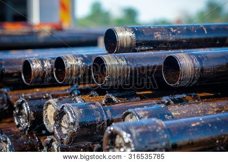 Oil Drill Pipe. Rusty Drill Pipes Were Drilled In The Well Section. Downhole Drilling Rig. Laying Th