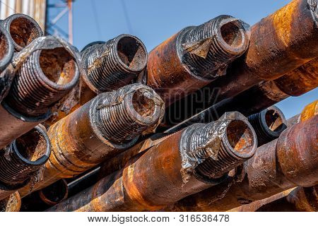 Oil Drill Pipe. Rusty Drill Pipes Were Drilled In The Well Section. Downhole Drilling Rig. Laying Th
